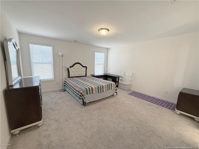 bedroom featuring light colored carpet