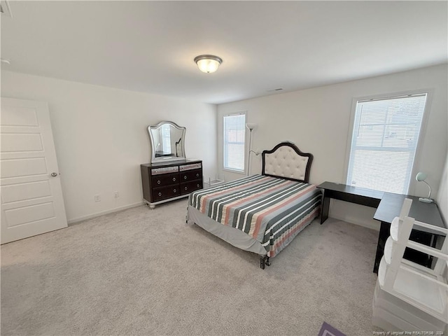 carpeted bedroom with multiple windows