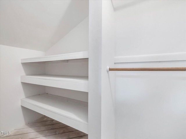 spacious closet featuring lofted ceiling and wood-type flooring