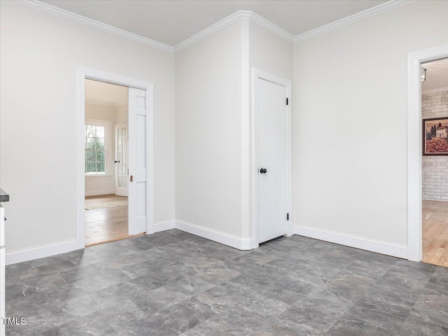 spare room with crown molding, brick wall, and dark hardwood / wood-style floors