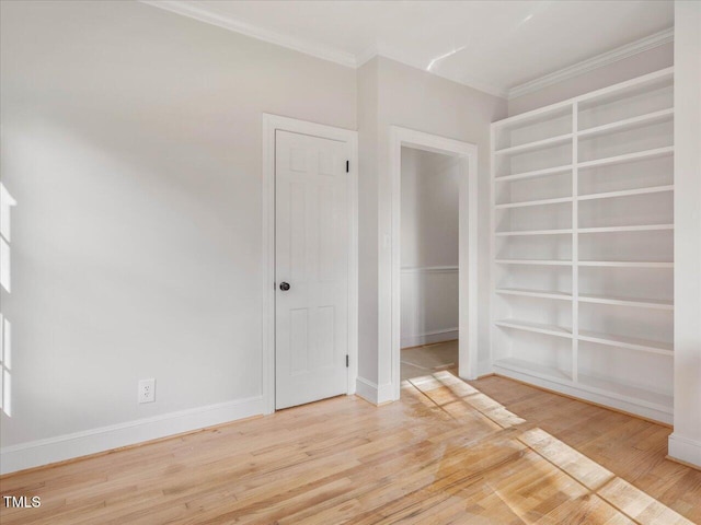 spare room featuring hardwood / wood-style floors and ornamental molding