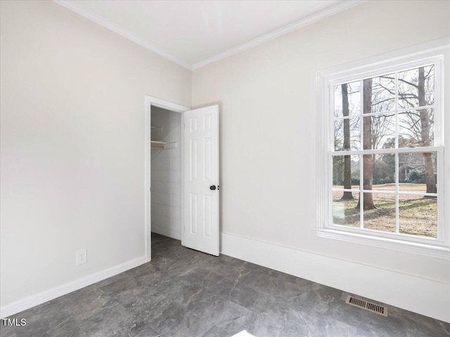 unfurnished bedroom featuring a closet, ornamental molding, and multiple windows