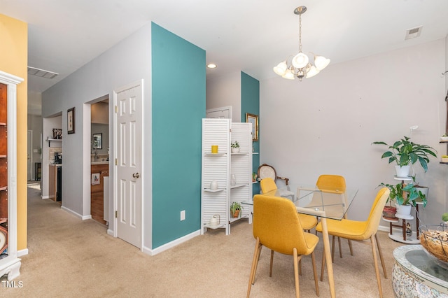 carpeted dining space featuring an inviting chandelier