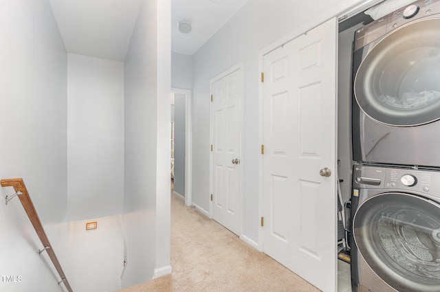 laundry area with light carpet and stacked washer and clothes dryer