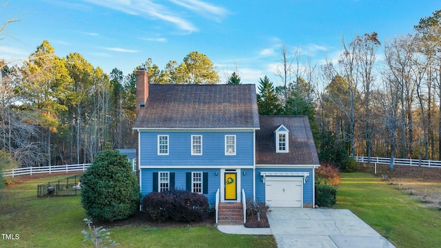 view of front of home with a garage and a front lawn