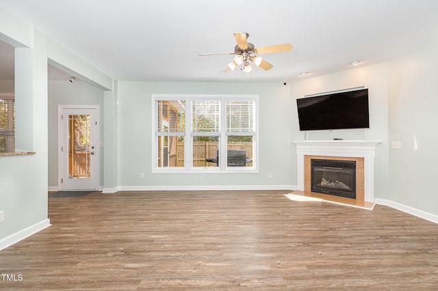 unfurnished living room with ceiling fan and light wood-type flooring