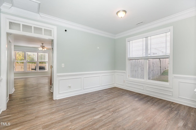 unfurnished room featuring ceiling fan, ornamental molding, and wood-type flooring