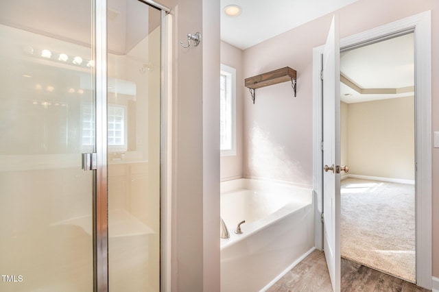 bathroom featuring separate shower and tub