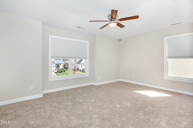 spare room with ceiling fan and carpet floors