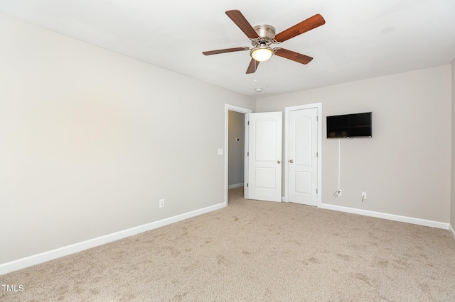 unfurnished bedroom featuring ceiling fan and carpet flooring