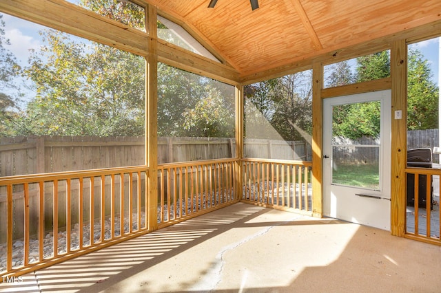 unfurnished sunroom featuring lofted ceiling and plenty of natural light