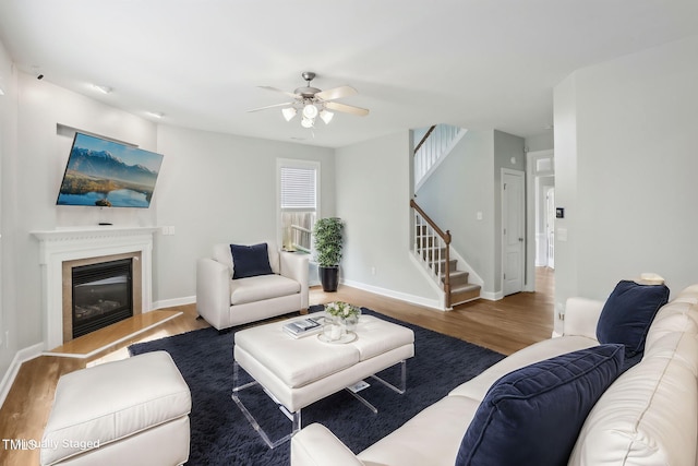 living room with wood-type flooring and ceiling fan