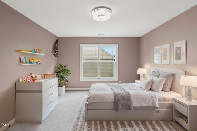 bedroom featuring light colored carpet