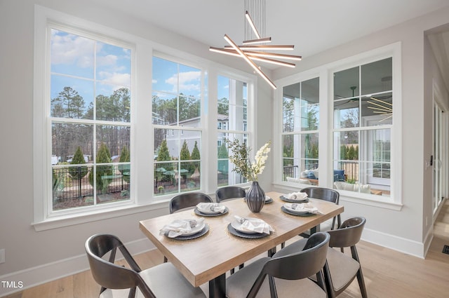 sunroom / solarium with a notable chandelier