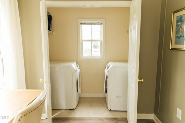 laundry area with washing machine and dryer and light tile patterned flooring