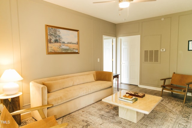 living room featuring hardwood / wood-style floors and ceiling fan