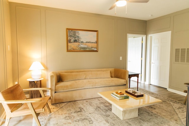 living room with ceiling fan and light wood-type flooring