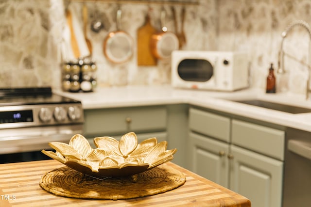 details with electric range, white dishwasher, and sink