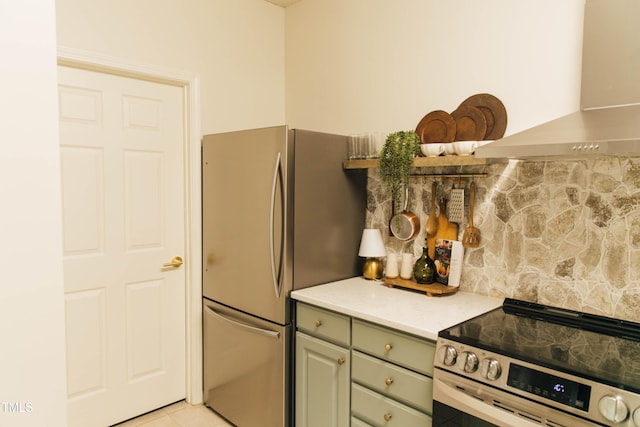 kitchen with stainless steel fridge, range with electric cooktop, light tile patterned floors, and island range hood