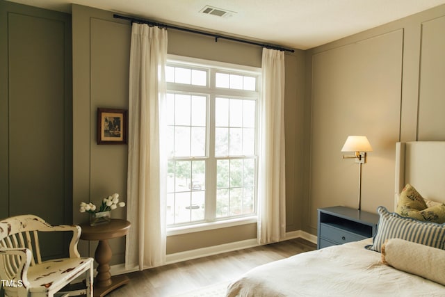 bedroom with hardwood / wood-style floors