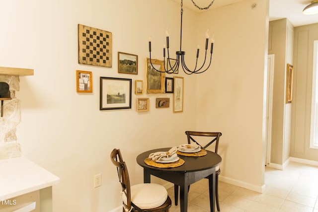 tiled dining space featuring a chandelier