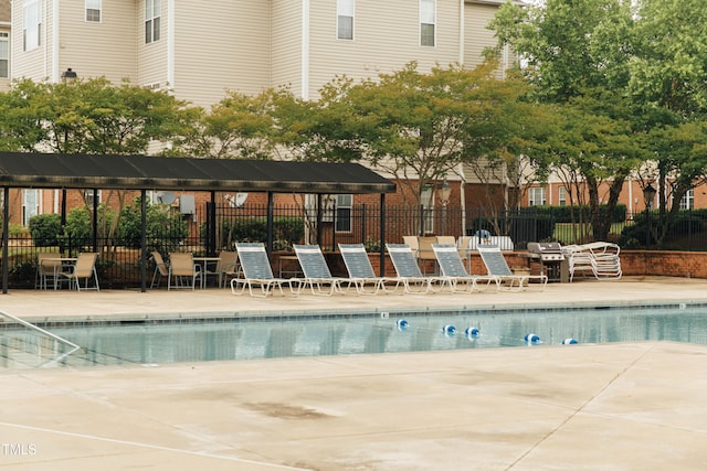 view of pool with a pergola and a patio