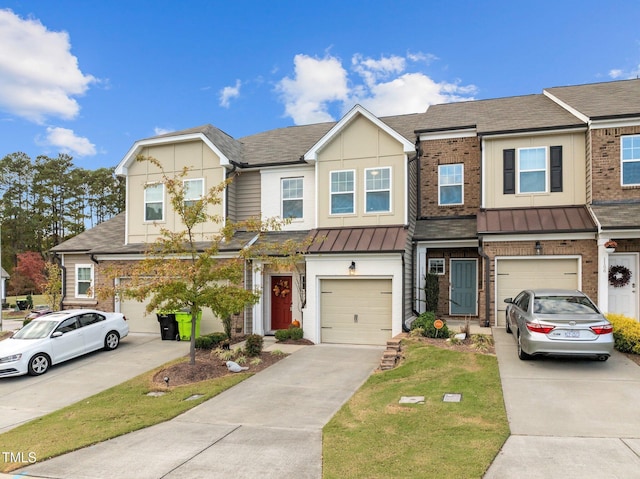 townhome / multi-family property featuring a front lawn and a garage