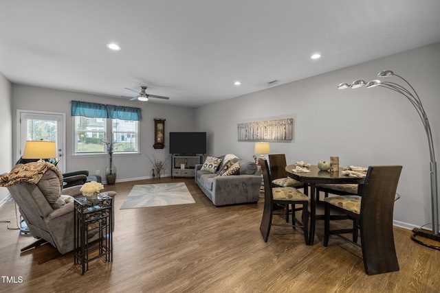 living room featuring hardwood / wood-style flooring and ceiling fan