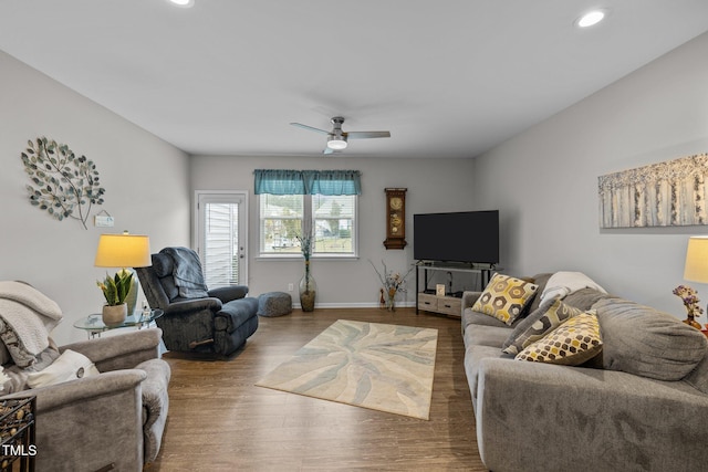 living room featuring ceiling fan and wood-type flooring