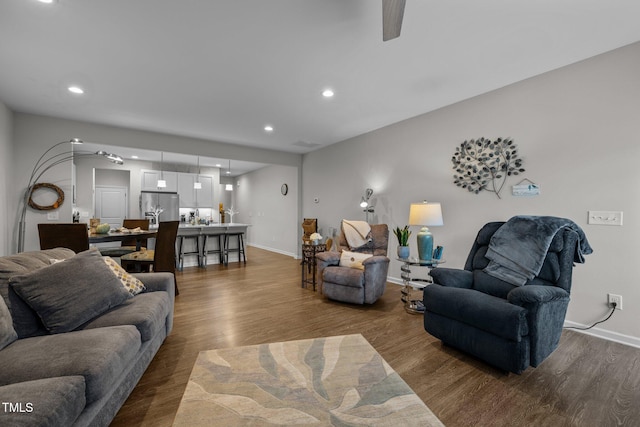 living room with hardwood / wood-style flooring and ceiling fan