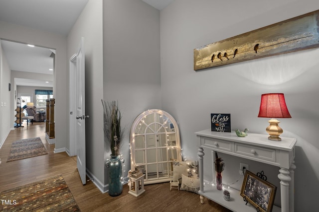 hallway with hardwood / wood-style flooring