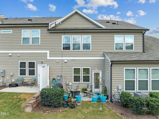 back of house with central AC and a patio