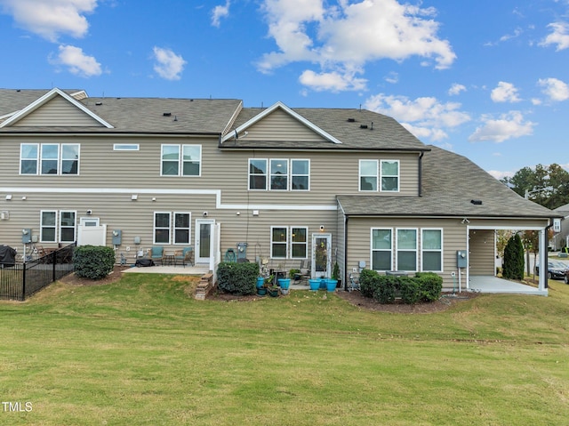 rear view of property featuring a patio area and a yard