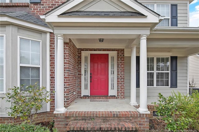 view of exterior entry featuring a porch