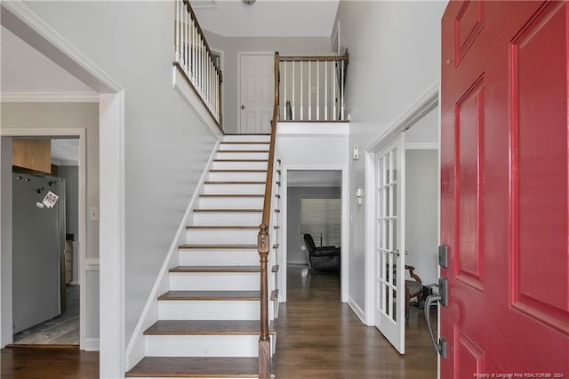 foyer entrance featuring dark hardwood / wood-style flooring and crown molding