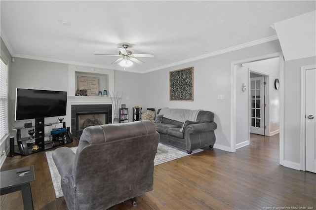 living room with dark hardwood / wood-style floors, ceiling fan, and crown molding