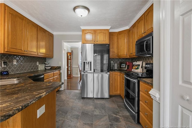 kitchen featuring backsplash, crown molding, sink, black appliances, and dark stone countertops