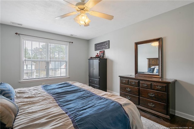 bedroom featuring ceiling fan and dark hardwood / wood-style floors