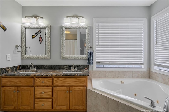 bathroom featuring vanity and tiled bath