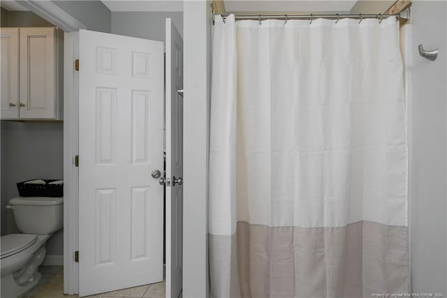 bathroom with tile patterned flooring and toilet