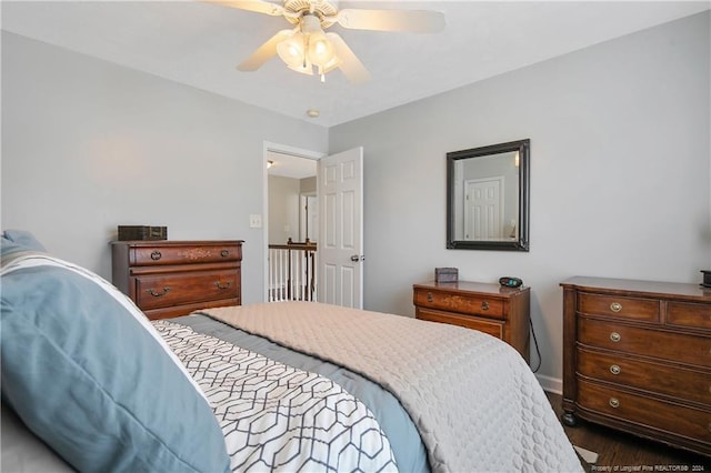 bedroom featuring ceiling fan and dark hardwood / wood-style floors