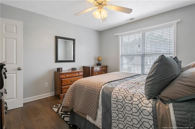 bedroom with ceiling fan and dark hardwood / wood-style flooring