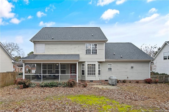 back of property with a sunroom and a patio