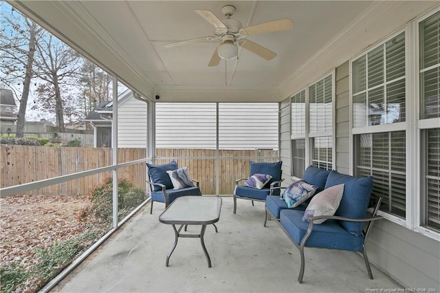 sunroom featuring ceiling fan