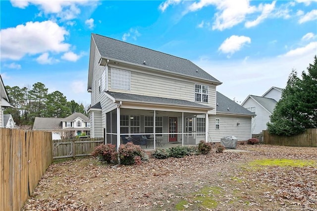 back of house with a sunroom and a patio