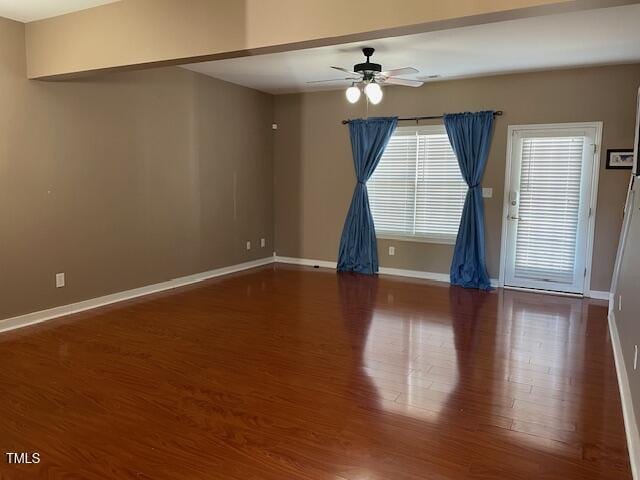 empty room with hardwood / wood-style flooring and ceiling fan