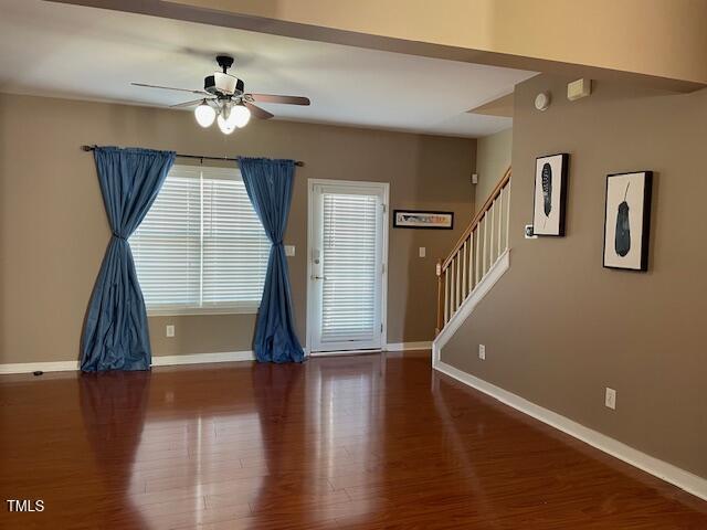 spare room with ceiling fan and wood-type flooring