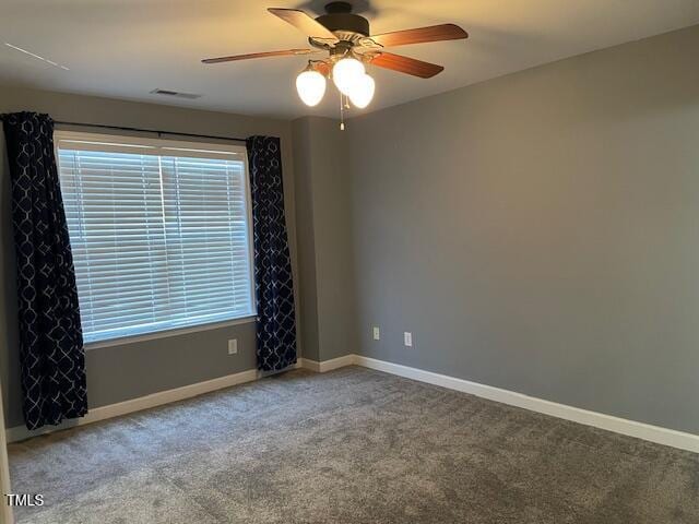 carpeted spare room with ceiling fan