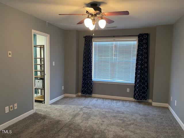 spare room featuring carpet floors and ceiling fan