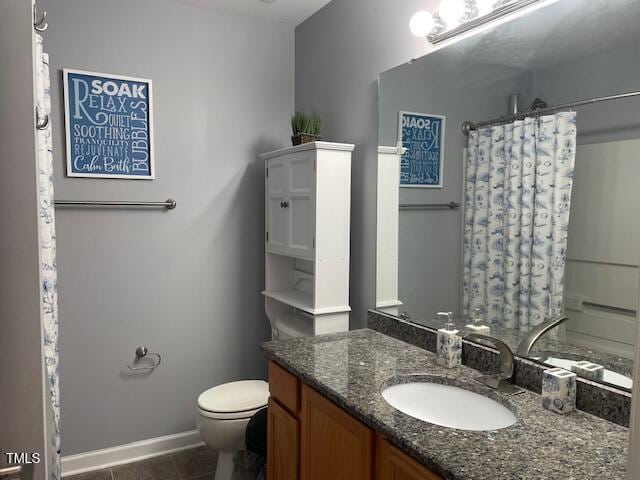 bathroom featuring vanity, toilet, curtained shower, and tile patterned flooring